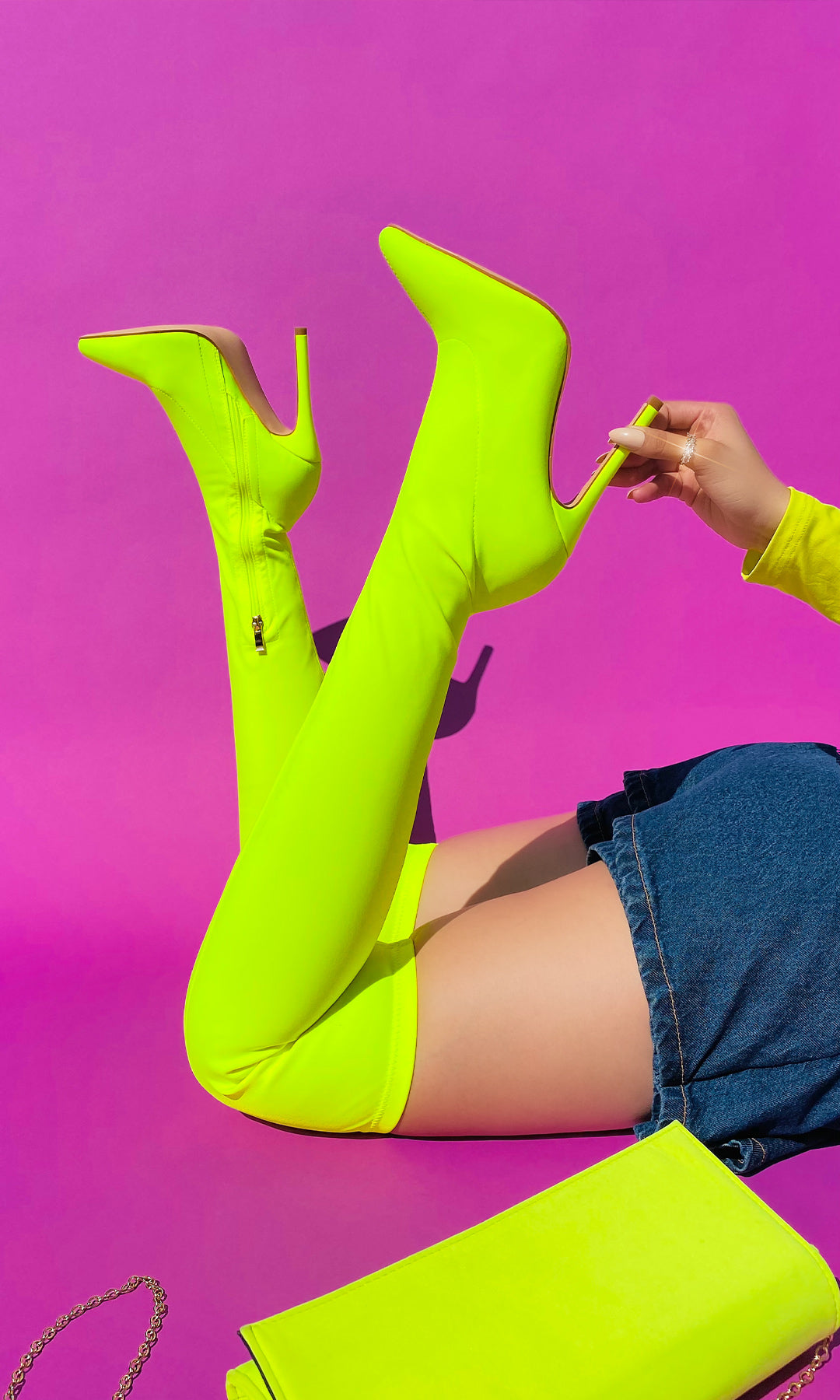 KINKY OUTFIT NEON PARA SALIR DE FIESTA LUCIENDO BOTAS LARGAS QUE CUBREN LA RODILLA CON FALDA SKORT DE MEZCLILLA Y BLUSA LISA