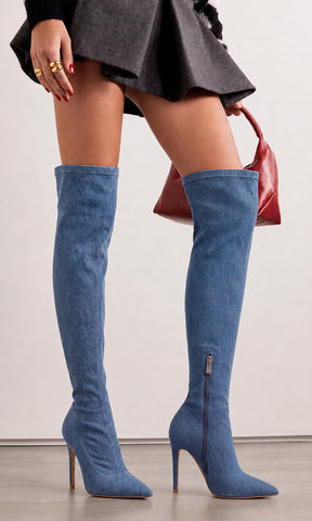 Botas altas KINKY azul mezclilla con tacón de aguja y punta fina, combinadas con vestido gris y bolso vino para un look elegante y sofisticado